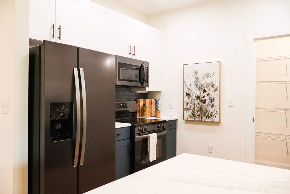 Modern kitchen with stainless steel appliances at Copper Trail Townhomes in Owasso, Oklahoma