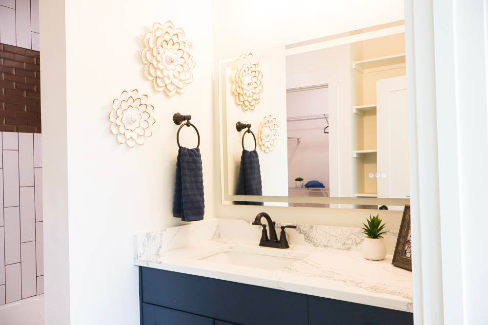 Stylish bathroom with marble countertops at Copper Trail Townhomes in Owasso, Oklahoma