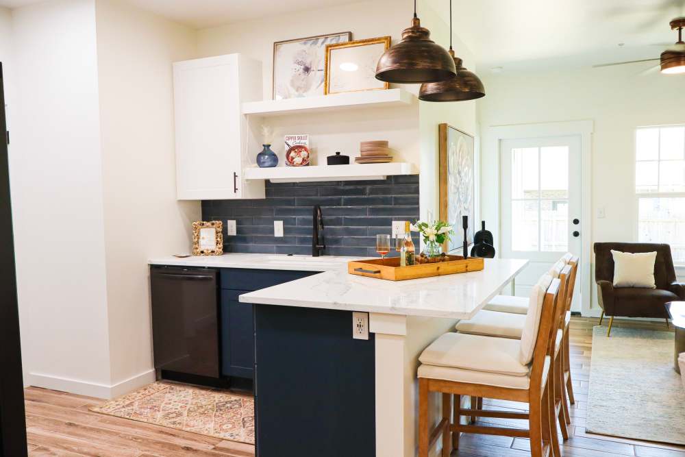 Modern kitchen with granite countertops and island at Copper Trail Townhomes in Owasso, Oklahoma