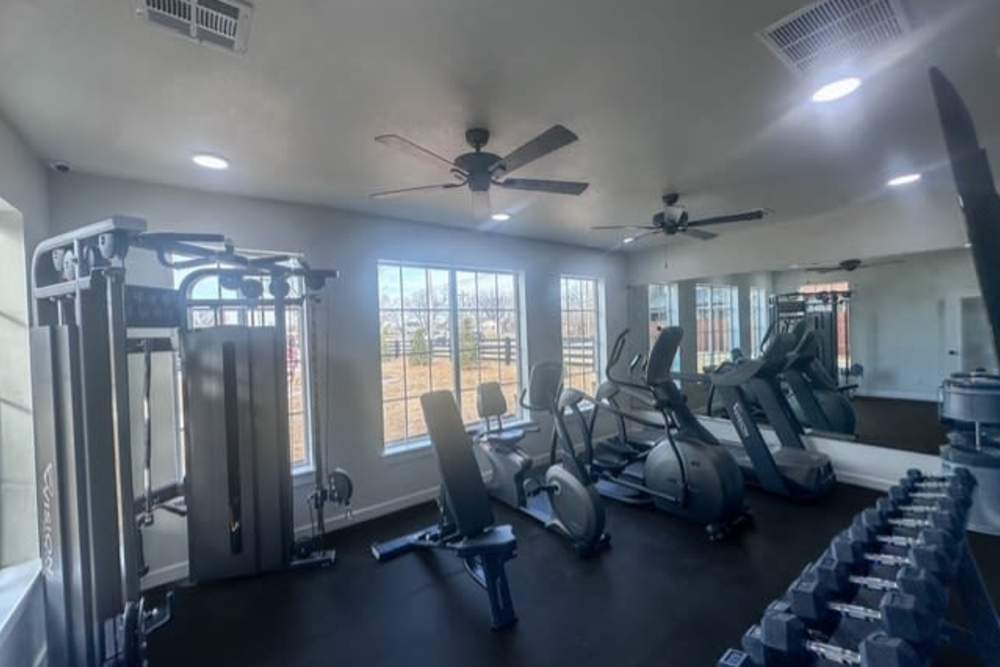 Bright fitness center with modern equipment at Copper Trail Townhomes in Owasso, Oklahoma