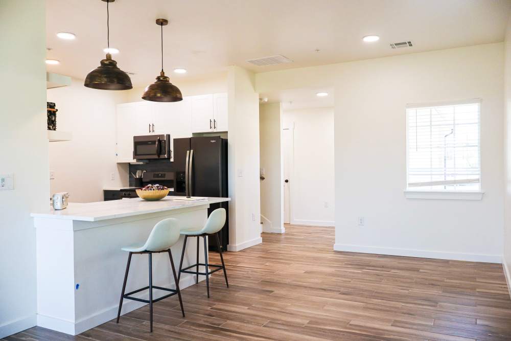 Modern kitchen with granite countertops and island at Copper Trail Townhomes in Owasso, Oklahoma