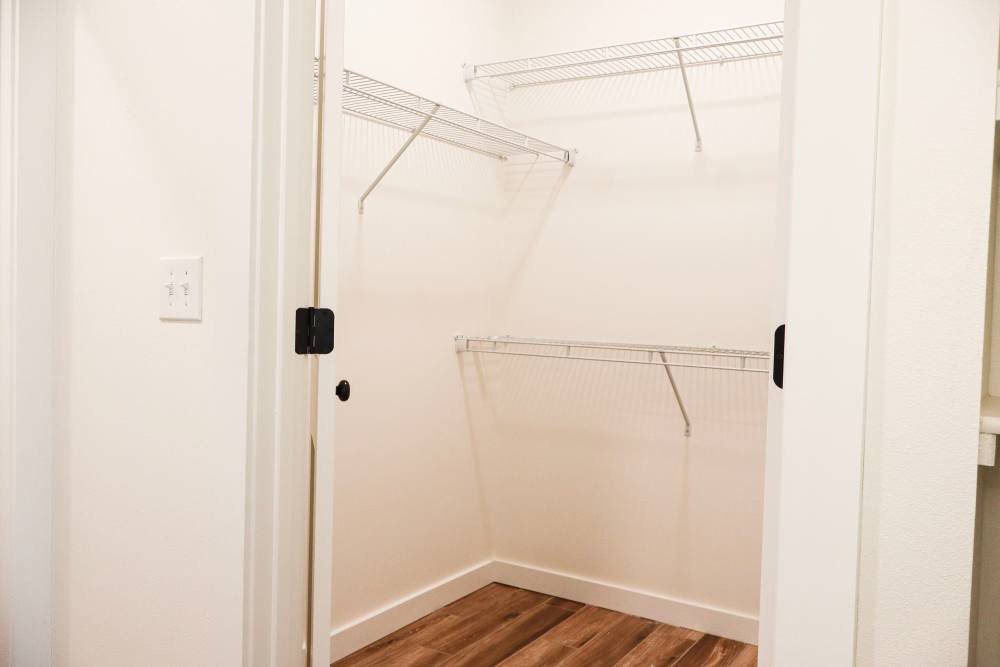 Spacious closet with wood-style flooring at Copper Trail Townhomes in Owasso, Oklahoma