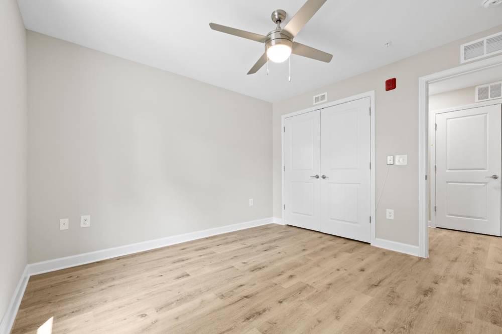 Empty bedroom with wood-style flooring at Bluebird Commons in Statesville, North Carolina