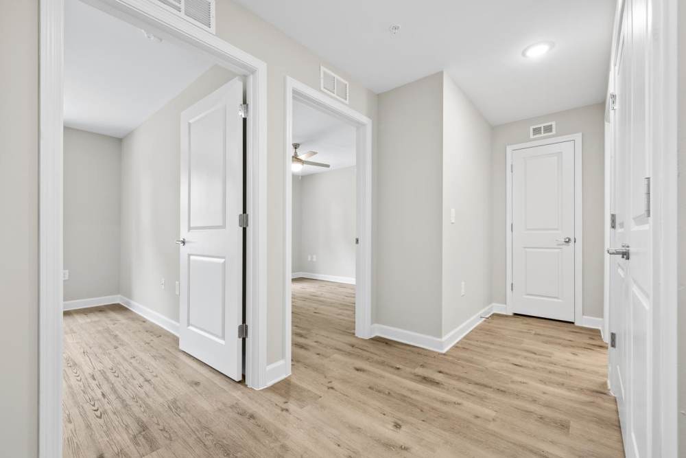 Spacious hallway with wood-style flooring at Bluebird Commons in Statesville, North Carolina