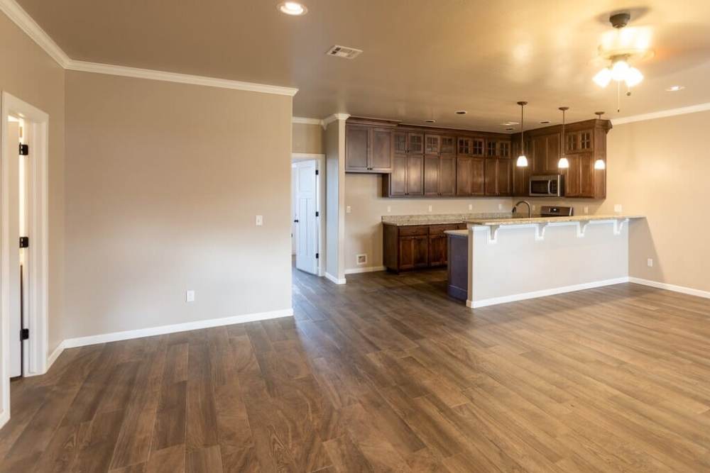 Living room with wooden flooring at Del Norte Duplexes in Yukon, Oklahoma 