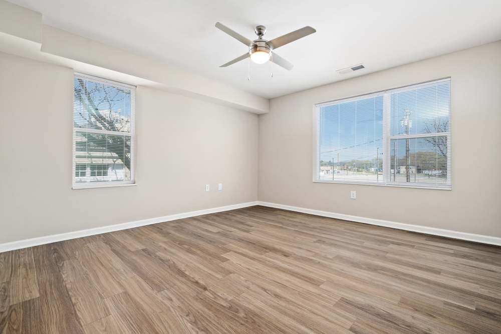 Spacious bedroom with wood-style flooring and window at Five Points Crossing in Rocky Mount, North Carolina