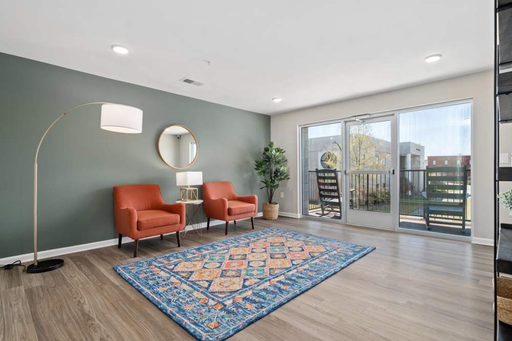 Cozy community room with balcony access at Five Points Crossing in Rocky Mount, North Carolina