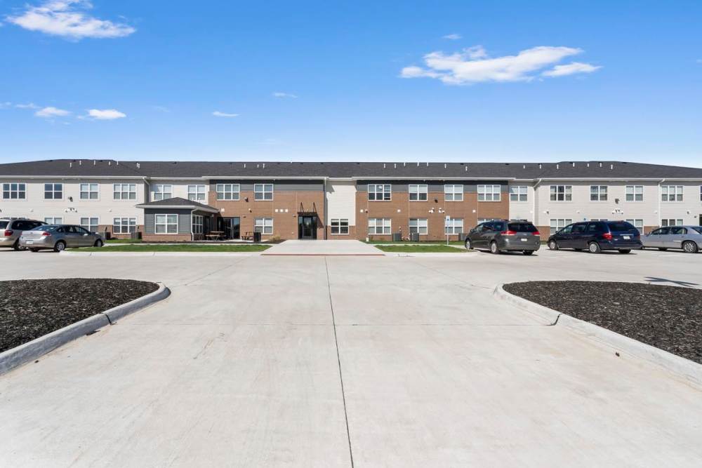 Modern apartment community with landscaped grounds and ample parking spaces at Chandler Pointe in Wilton, Iowa