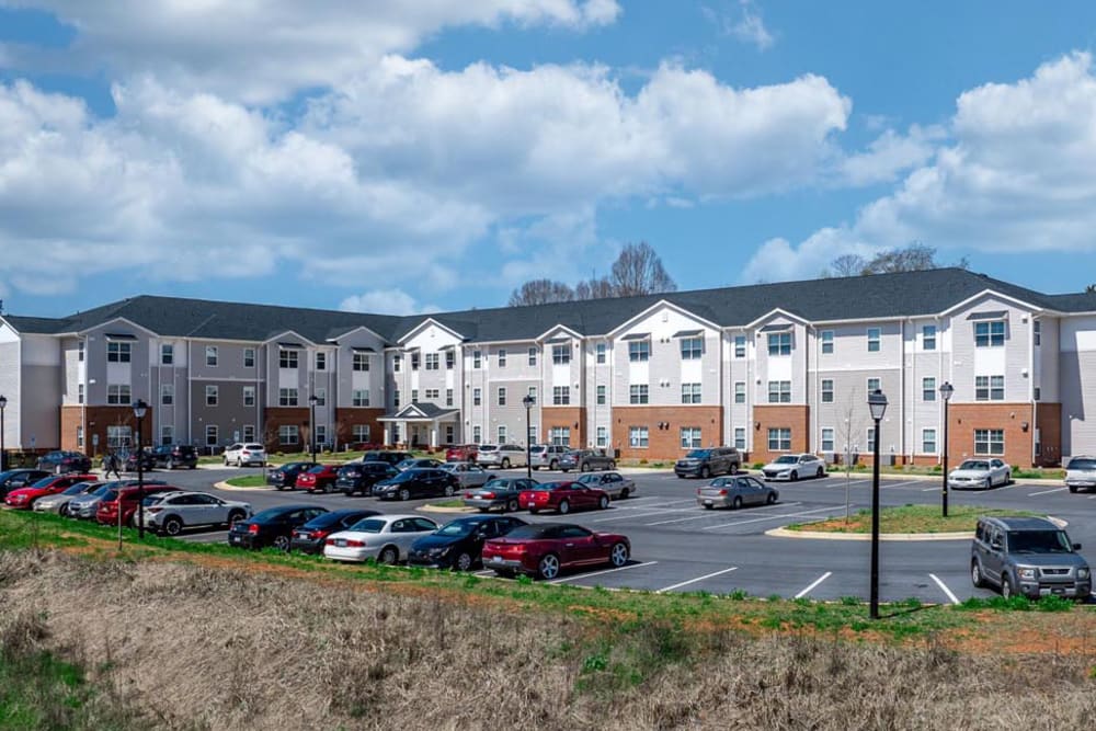 Parking lot filled with cars at apartment community near Landon Greene in Statesville, North Carolina