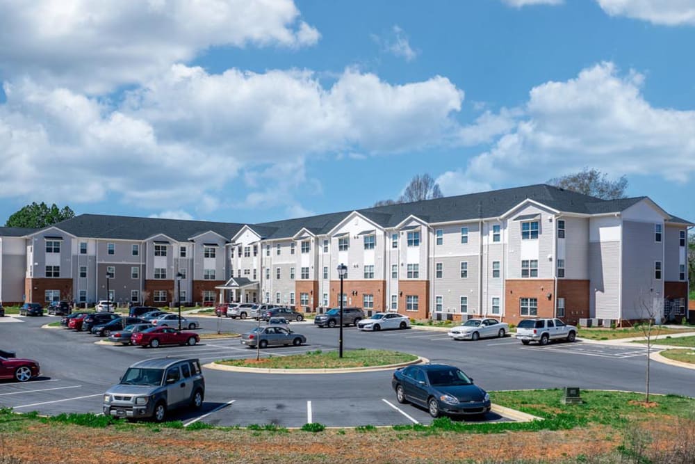 Apartment building with parking lot at Landon Greene in Statesville, North Carolina