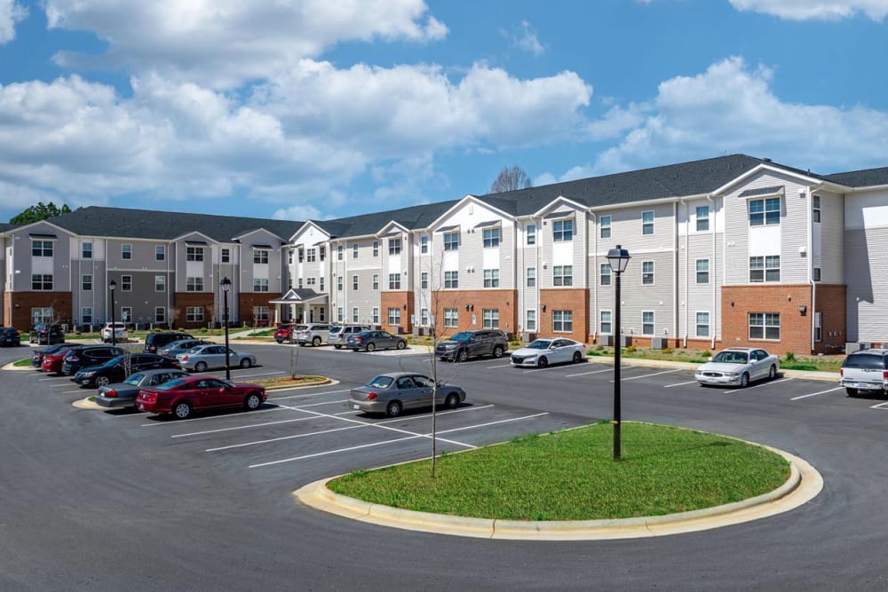 Parking lot with landscaped green space at Landon Greene in Statesville, North Carolina