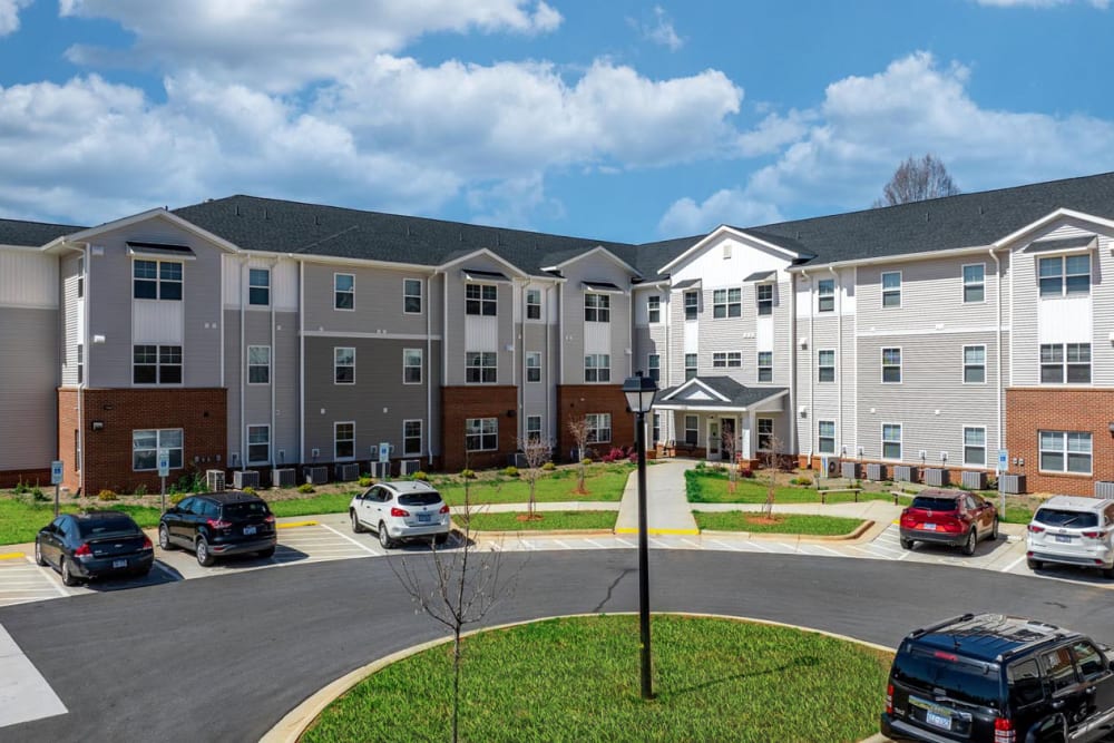 Apartment building exterior with parking at Landon Greene in Statesville, North Carolina
