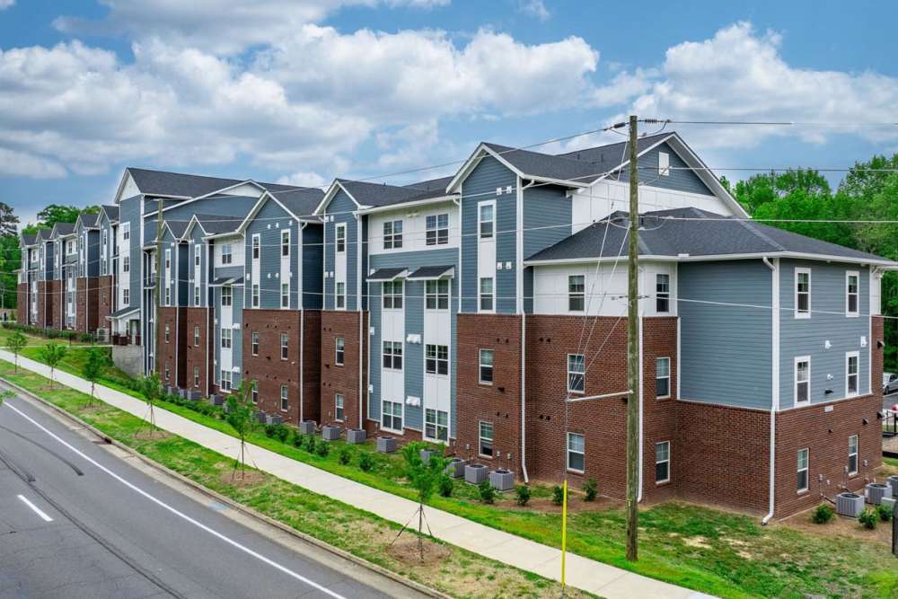 Modern apartment building with landscaped path near Northlake Center Apartments in Charlotte, North Carolina
