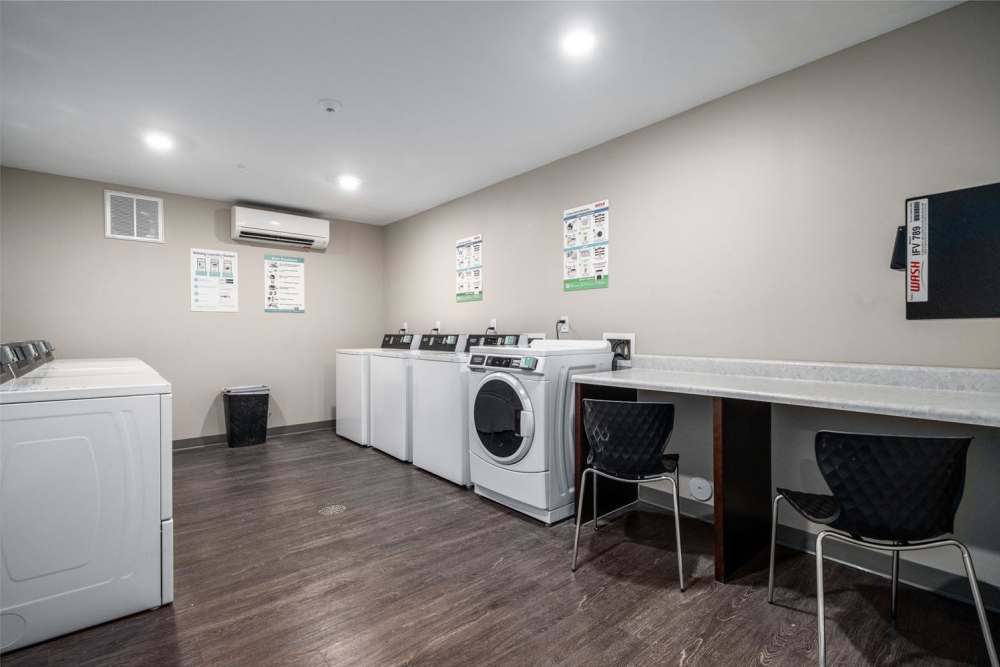 Bright laundry room with modern machines at Northlake Center Apartments in Charlotte, North Carolina
