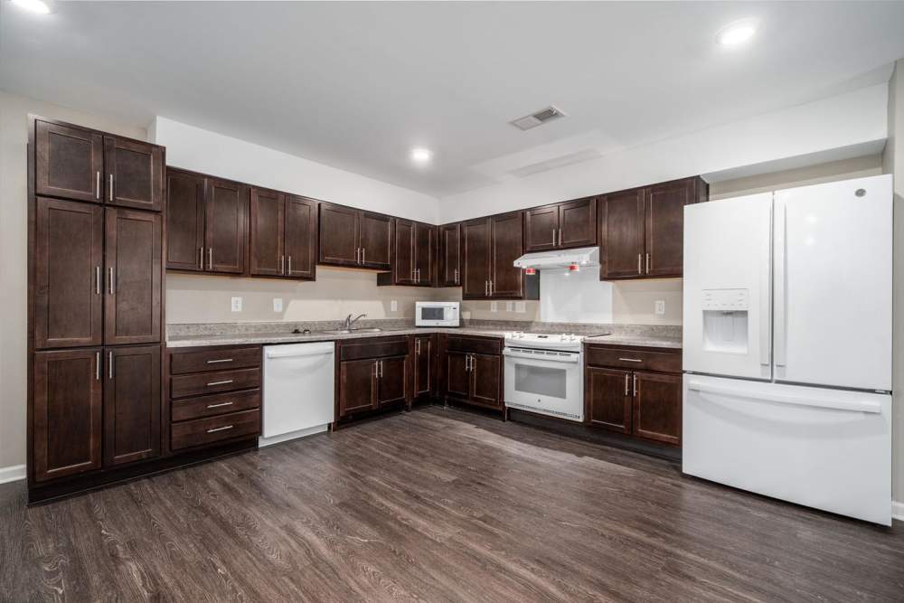 Modern kitchen with granite countertops and wooden cabinetry at Northlake Center Apartments in Charlotte, North Carolina