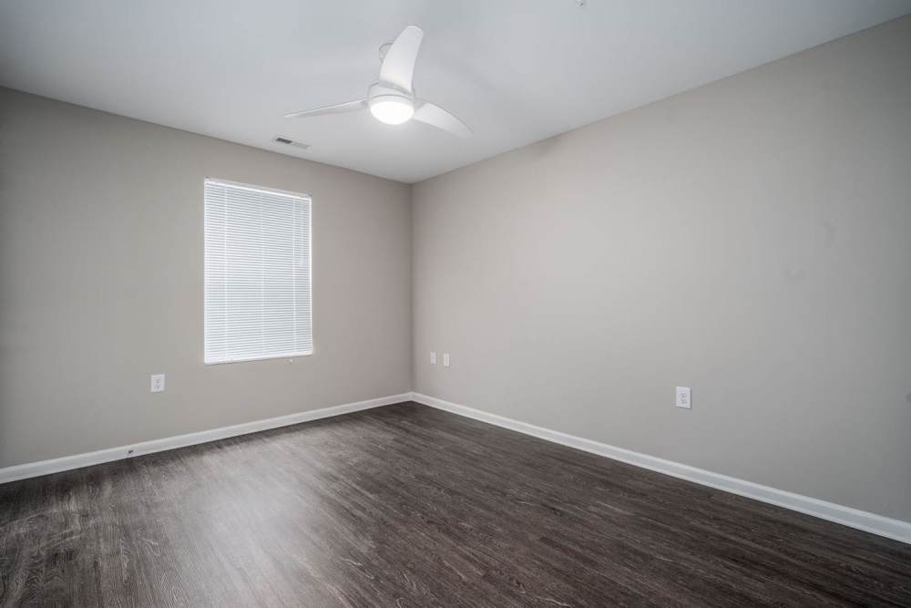 Bedroom with wood-style flooring and ceiling fan at Northlake Center Apartments in Charlotte, North Carolina