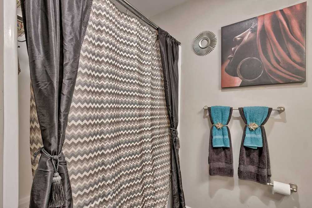 Stylish bathroom with chevron shower curtain and decorative towels at Lowcountry Crossing in Denmark, South Carolina