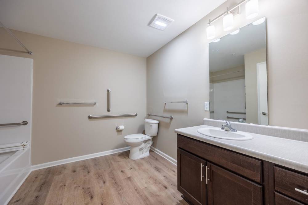 Bathroom with wood-style flooring at Pender Crossing in Wilson, North Carolina