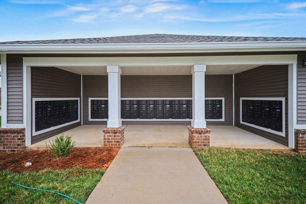 Covered mail area with multiple mailboxes and landscaped grass surrounding the entrance at Rutherford Crossing in Cherryville, North Carolina