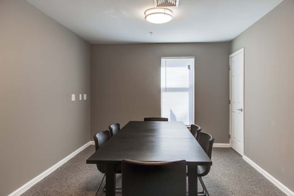 Modern dining area with a large table and black chairs, natural light from window at Viewmont Square in Hickory, North Carolina