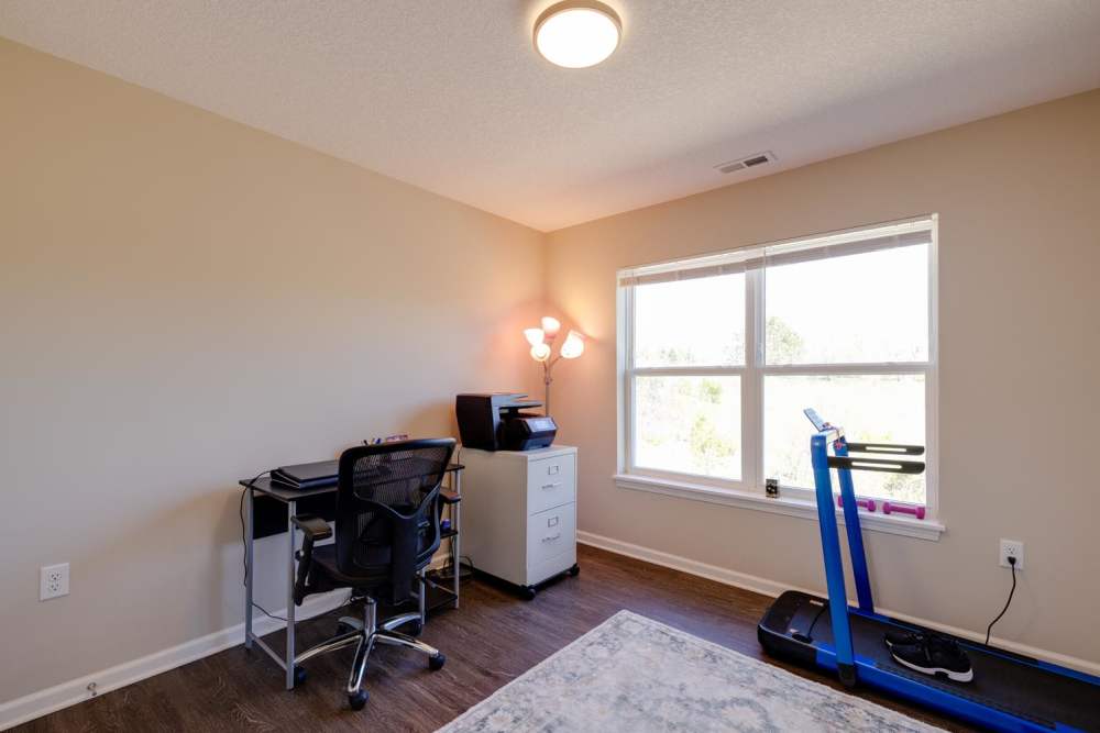 Home office with desk, printer, and treadmill at Williams Terrace in Indianola, Iowa