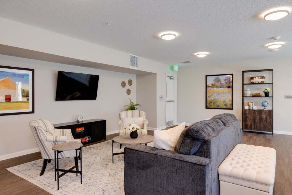 Modern lounge area with comfortable seating and TV at Williams Terrace in Indianola, Iowa