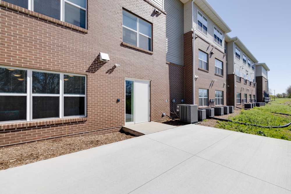 Exterior view of apartment building with patio area at Williams Terrace in Indianola, Iowa