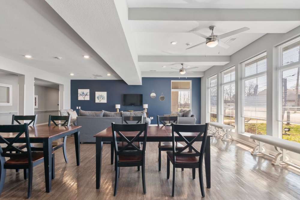 Bright open layout with wood-style flooring, dining tables, and large windows for natural light at Kirkman Terrace in Hopkinsville, Kentucky