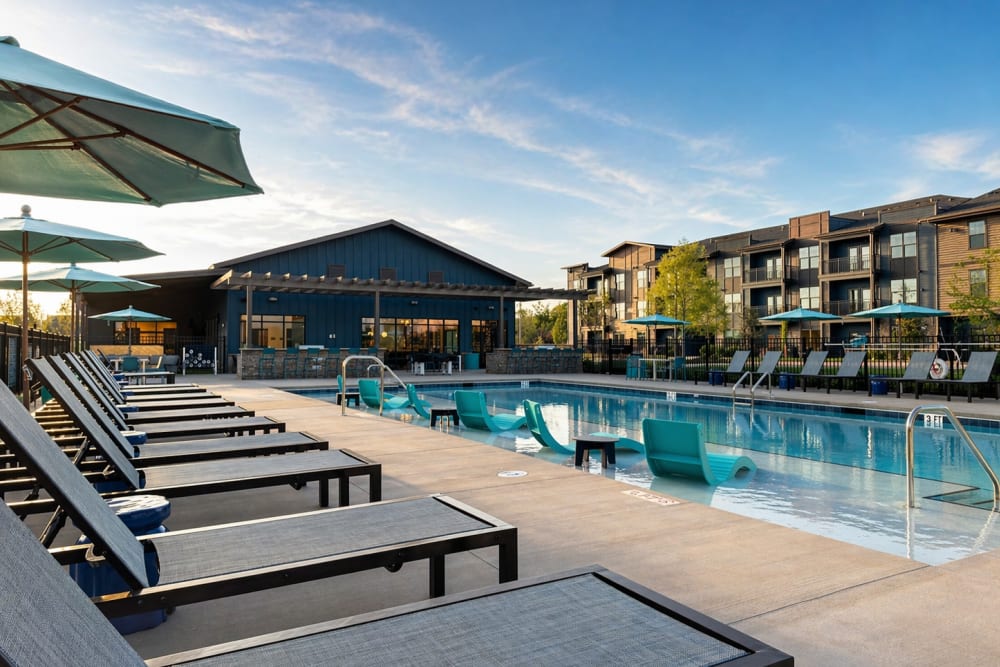 Luxury pool at apartment community in Mooresville, NC with lounge chairs.
