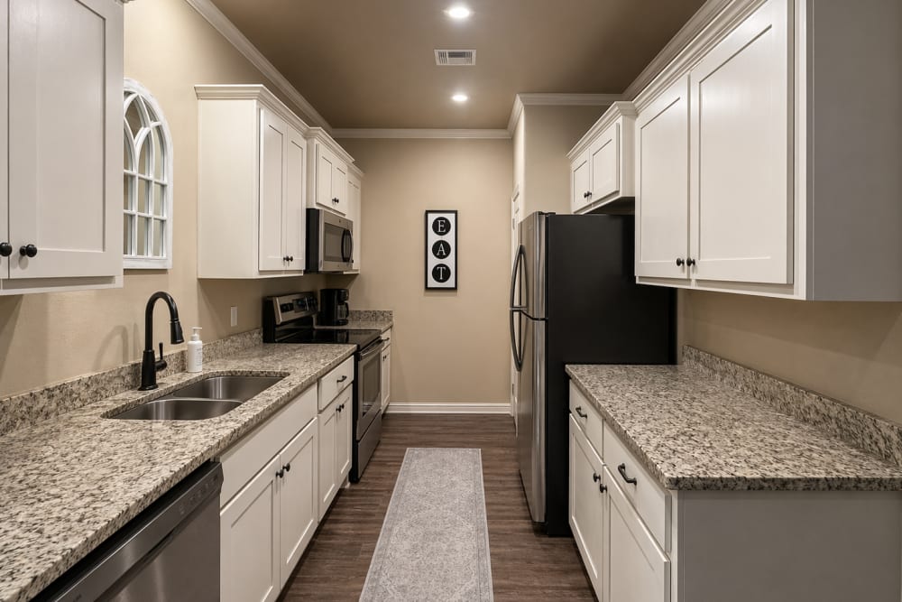 Kitchen with wooden cabinets at Villas at Stonebridge in Owasso, Oklahoma