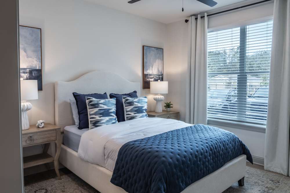 Bedroom with blue bedding and nightstands at The Flats at Crosspointe in Columbia, South Carolina