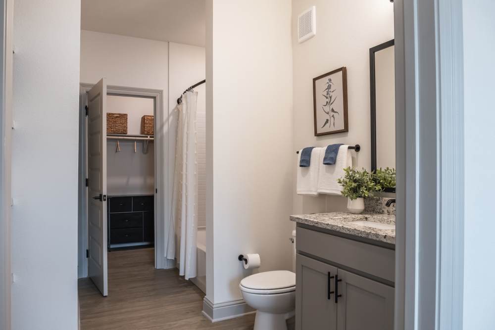 Hallway with doors and wood-style flooring at The Flats at Crosspointe in Columbia, South Carolina