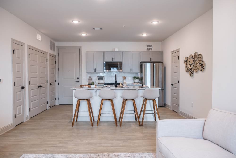 Kitchen island with seating and pendant lighting at The Flats at Crosspointe in Columbia, South Carolina