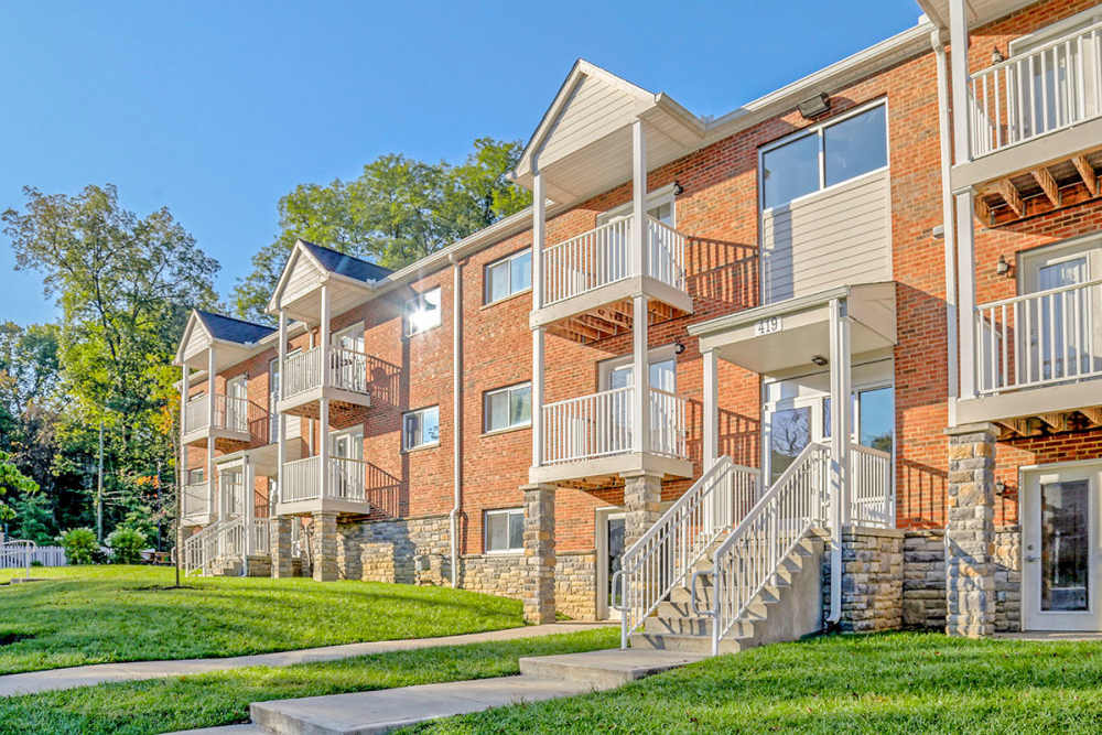 Brick apartment building with balconies and stone accents at Alston Park in Cincinnati, Ohio