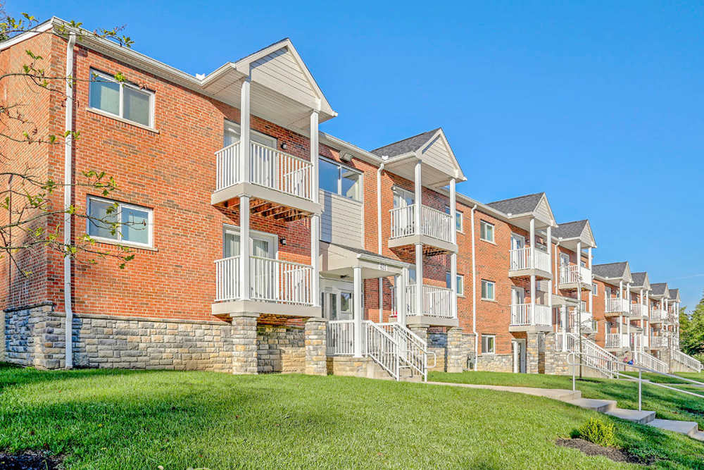 Brick apartment buildings with landscaped green space in front at Alston Park in Cincinnati, Ohio
