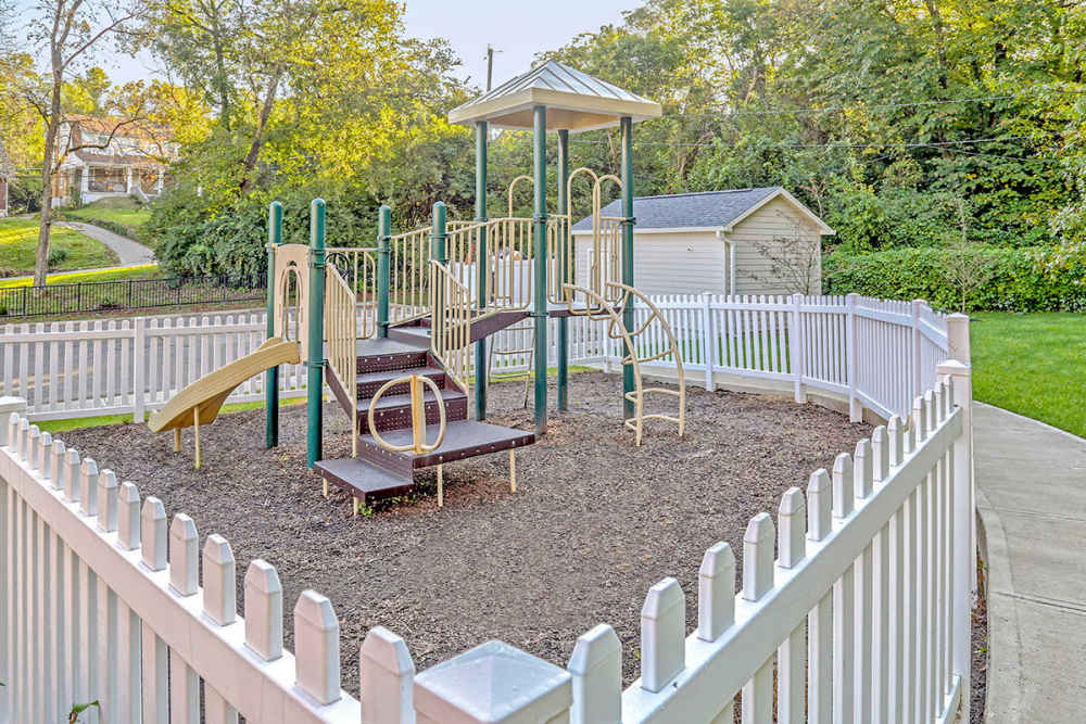 Fenced playground with climbing structure at Alston Park in Cincinnati, Ohio