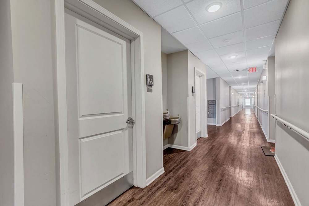 Corridor with multiple doors at Audubon Crossing Senior Community in Dayton, Ohio