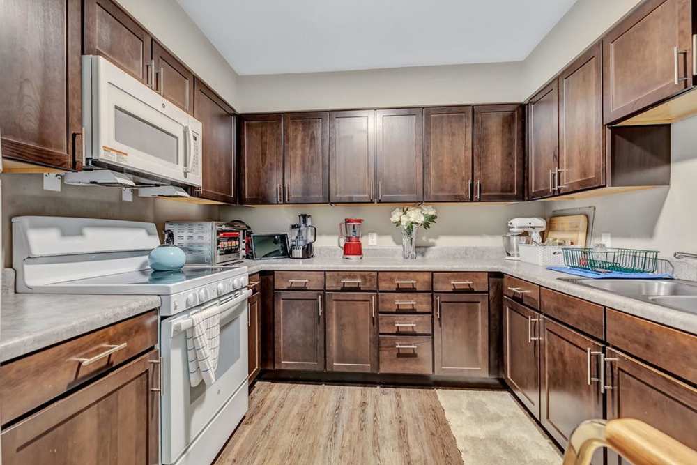 Modern kitchen with wooden cabinets at Audubon Crossing Senior Community in Dayton, Ohio 