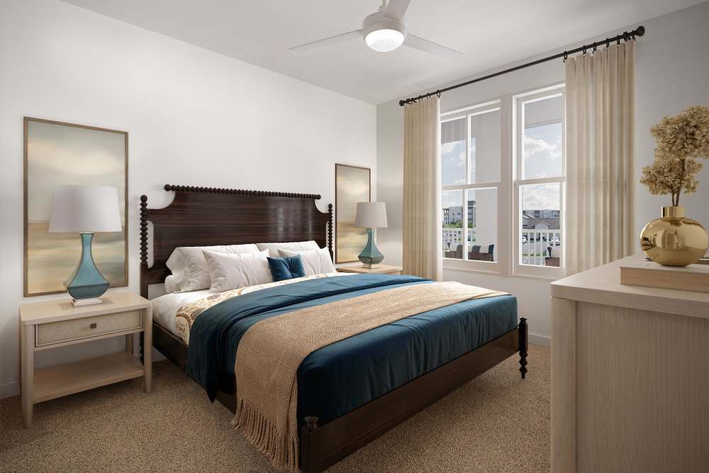 Cozy bedroom with large windows at Romero Apartments in Pensacola, Florida
