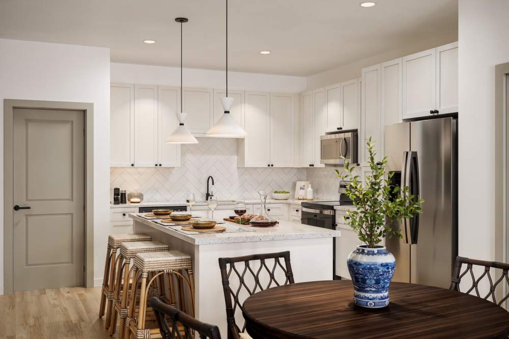 Modern kitchen with island and stainless steel appliances at Romero Apartments in Pensacola, Florida