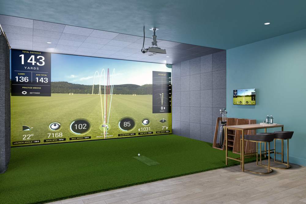 Golf simulator room with seating area at Romero Apartments in Pensacola, Florida