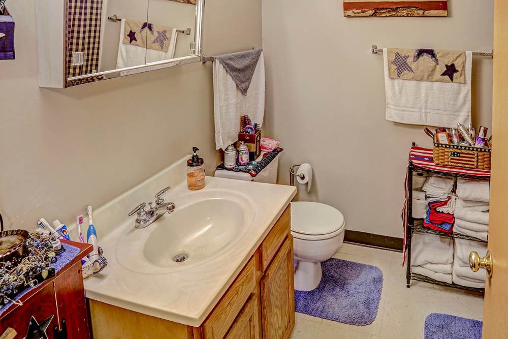 Vanity with sink and wooden cabinet at Glennview Apartments in Washington Court House, Ohio