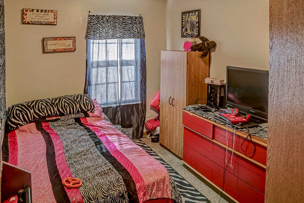 Zebra-patterned bedding in cozy bedroom at Glennview Apartments in Washington Court House, Ohio