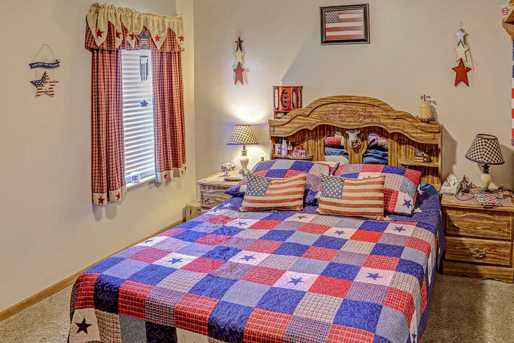Bright bedroom with patriotic bedding at Glennview Apartments in Washington Court House, Ohio