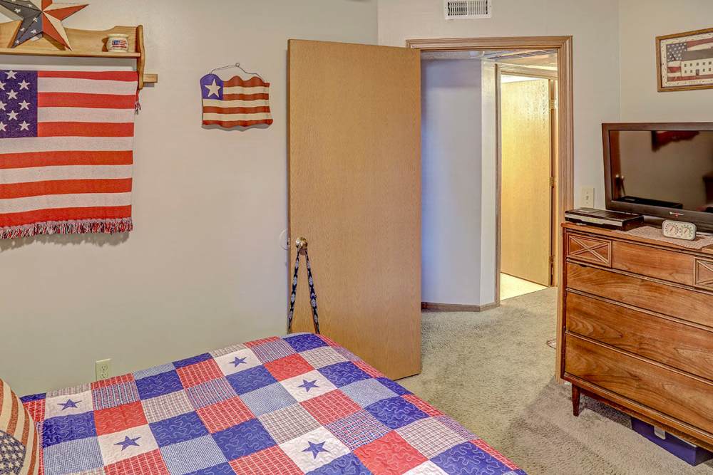 Cozy bedroom with patriotic decor at Glennview Apartments in Washington Court House, Ohio