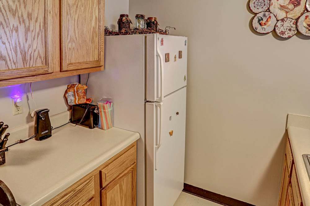 Bright kitchen with wood cabinetry at Glennview Apartments in Washington Court House, Ohio