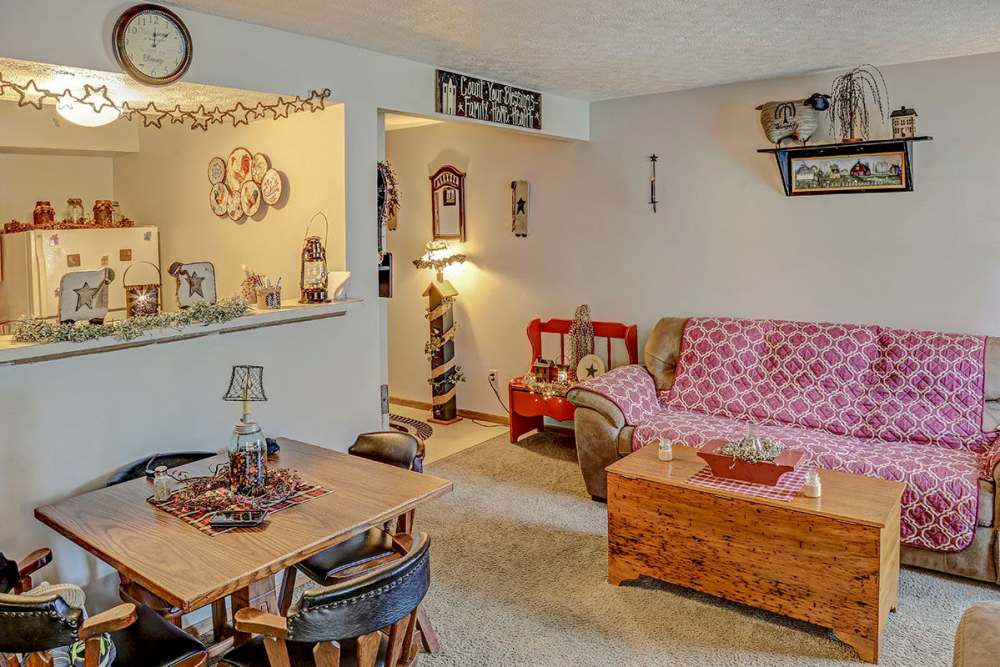 Cozy dining area with wooden table at Glennview Apartments in Washington Court House, Ohio