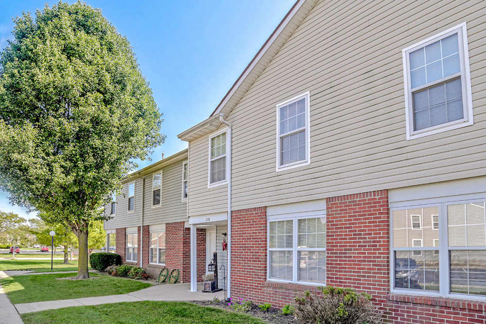 Bright exterior with landscaped entrance at Glennview Apartments in Washington Court House, Ohio