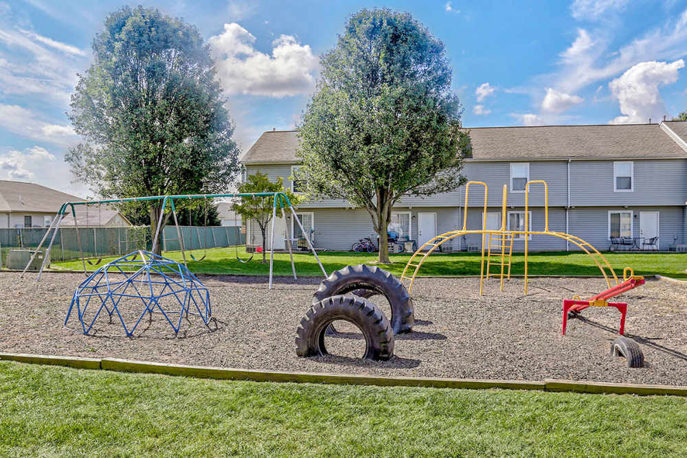 Playground with swings and climbing structures at Glennview Apartments in Washington Court House, Ohio