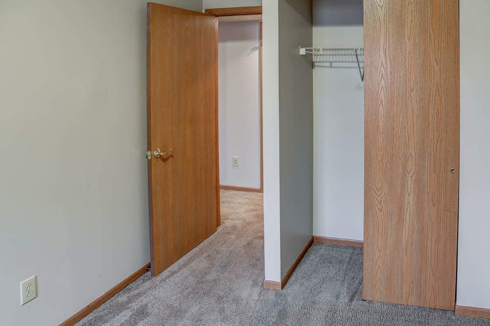 Carpeted bedroom with open closet space at Riverview Place in Ripley, Ohio